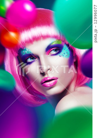 woman with balloons around woman with balloons around 12996077