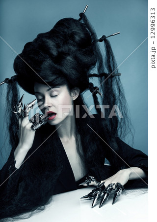Fashion shot of a woman with bunch of hair on had Fashion shot of a woman with bunch of hair on had 12996313