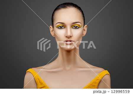 Portrait of woman with yellow eyeshadow 12996559