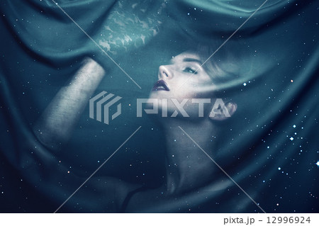 woman in gloves through fabric with stars woman in gloves through fabric with stars 12996924
