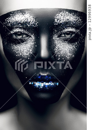 woman with black mask and blue lips 12996938