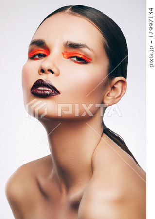 brunette woman with orange eyelids 12997134