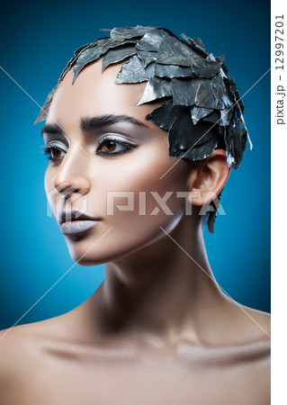 pretty woman in hat of silver leaves 12997201