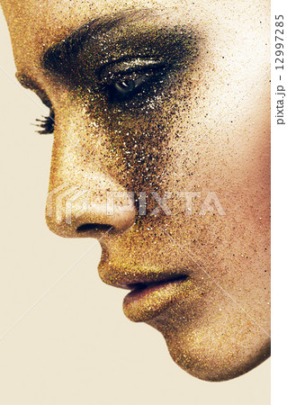 woman face in gold glitters woman face in gold glitters 12997285