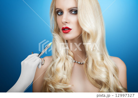 Woman gets an injection in her face 12997327