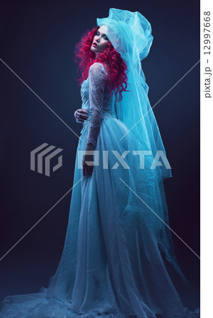 woman in turquoise dress with red hair 12997668