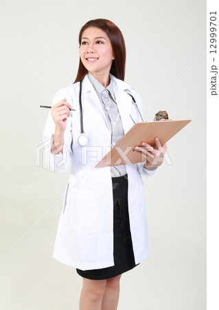 Female Doctor Holding Clipboard and Pen Looking side 12999701