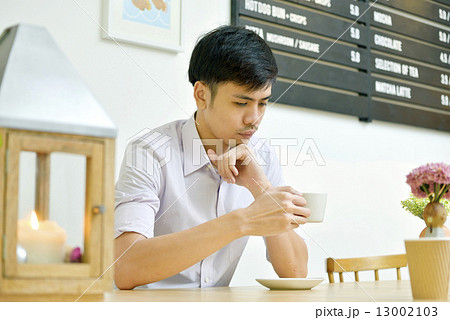 Asian Men Having Coffee at Cafe . Asian Men Having Coffee at Cafe . 13002103