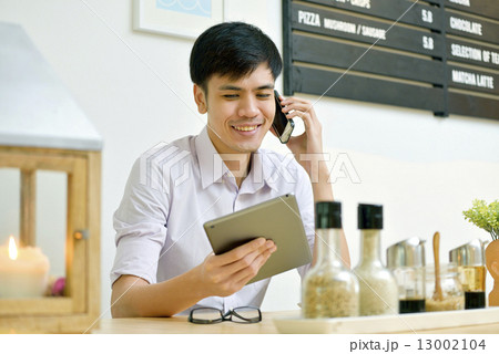 Asian Men , Using ipad , Handphone in Cafe Asian Men , Using ipad , Handphone in Cafe 13002104