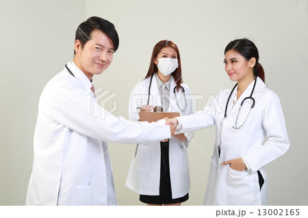 male and femae doctors group hand shake greeting  13002165