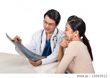 Doctor discussing with patient over medical condition Doctor discussing with patient over medical condition 13002612