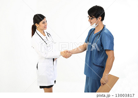 female and male doctor in uniform congatulate by handshake female and male doctor in uniform congatulate by handshake 13003817