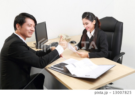 Man thumbs up good female study document at office  13007825