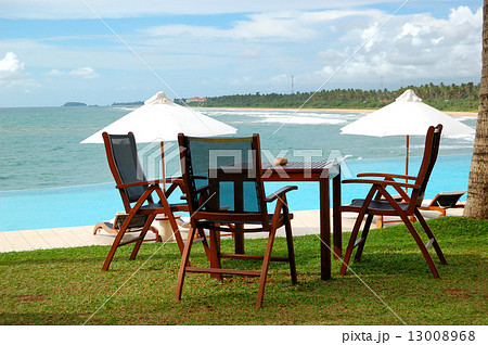 Sunbeds and chair of outdoor restaurant at the sea view swimming 13008968