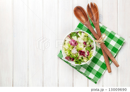 Fresh healthy salad and kitchen utensils 13009690