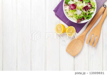 Fresh healthy salad and kitchen utensils 13009691