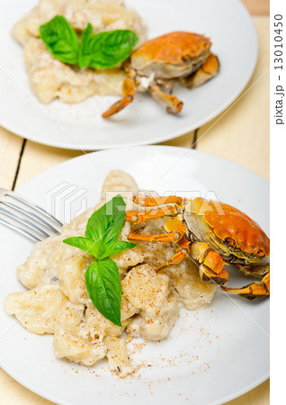 Italian gnocchi with seafood sauce with crab and basil 13010450