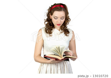 Portrait of pinup woman reading book 13010720