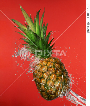 Splash in water with pineapple 13011438