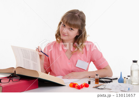 Pharmacist enjoy reading medication guide 13011657