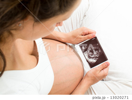 pregnant woman looking at baby scan pregnant woman looking at baby scan 13020271