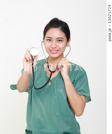 Lady doctor in uniform holding stethoscope 13021724