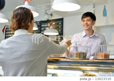 Waiter and Customer at a Cafe. 13023510