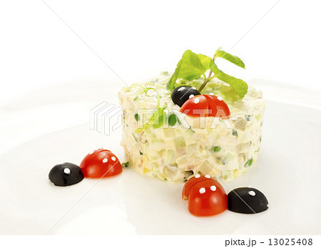 Olivier salad decorated with tomato in the shape of ladybugs 13025408