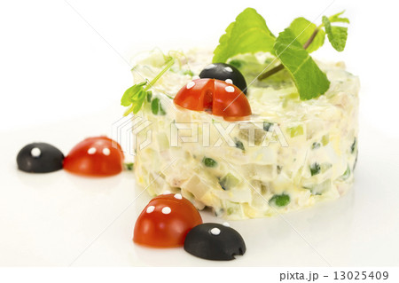 Olivier salad decorated with tomato in the shape of ladybugs 13025409