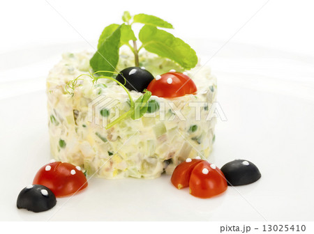 Olivier salad decorated with tomato in the shape of ladybugs 13025410