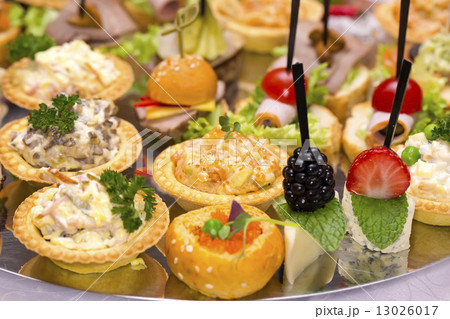 Canapes of cheese vegetables meat and seafood on white background Canapes of cheese vegetables meat and seafood on white background 13026017