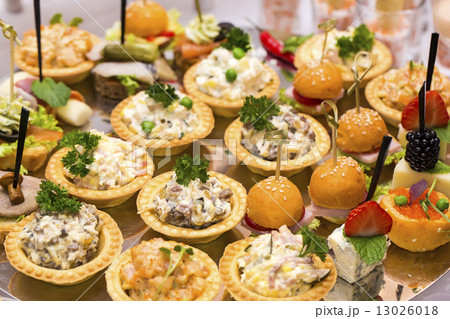 Canapes of cheese vegetables meat and seafood on white background Canapes of cheese vegetables meat and seafood on white background 13026018
