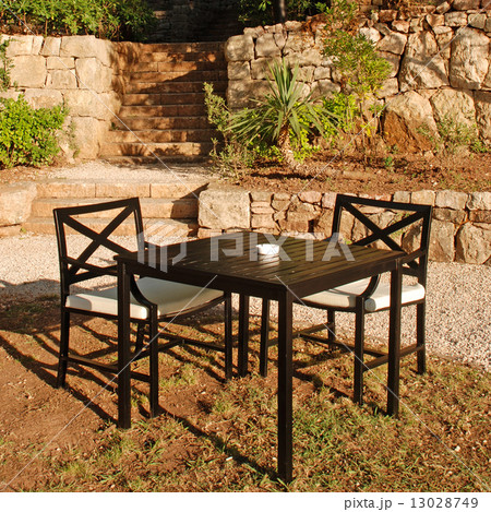 Table and chair in outdoor cafe, Italy. 13028749