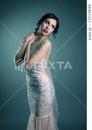 Beautiful brunette posing in elegant evening dress 13029699