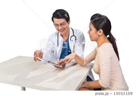 Doctor discussing with patient over medical condition 13032109