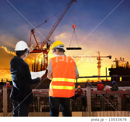 engineering man working in building construction site with worke 13033676