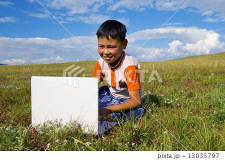Mongolian Boy with Laptop on Grass Mongolian Boy with Laptop on Grass 13035797
