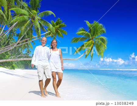 A couple walking on the beach A couple walking on the beach 13038249