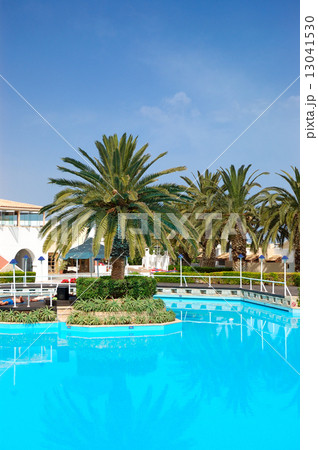 Swimming pool and palm trees at the luxury hotel, Crete, Greece Swimming pool and palm trees at the luxury hotel, Crete, Greece 13041530
