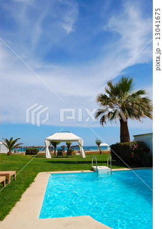 Swimming pool with jacuzzi at the beach of modern luxury villa, 13041675