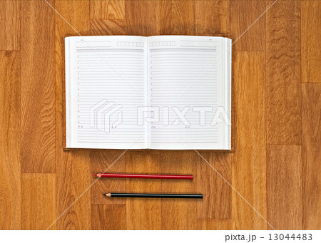 Blank notepad with office supplies on wooden table. 13044483