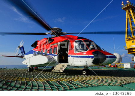 The helicopter park on oil rig to pick up worker The helicopter park on oil rig to pick up worker 13045269