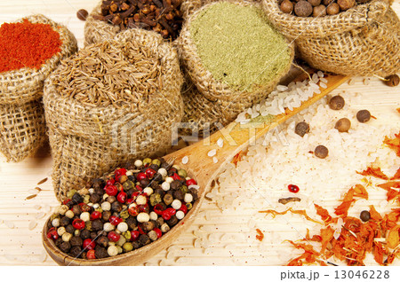 Powder spices on spoon and in pouches on a wooden table background Powder spices on spoon and in pouches on a wooden table background 13046228