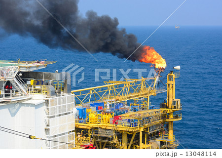The gas flare is on the offshore oil rig The gas flare is on the offshore oil rig 13048114