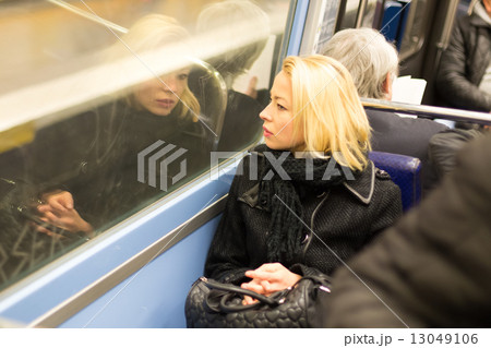 Woman looking out metro's window. Woman looking out metro's window. 13049106
