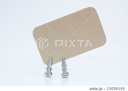 blank note on brown paper with two metal pins 13056193