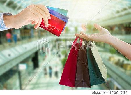 hands holding bags and credit cards 13064253