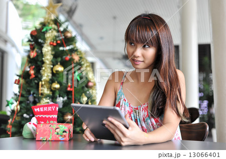 Portrait of a young and beautiful lady waiting at cafe for friends to celebrate christmas together Portrait of a young and beautiful lady waiting at cafe for friends to celebrate christmas together 13066401