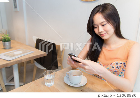 Lady texting in Cafe 13068930