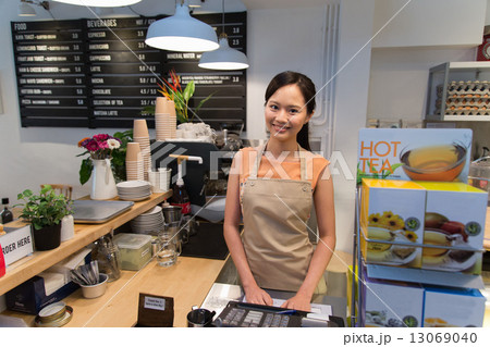 Smiling waitress at the counter Smiling waitress at the counter 13069040